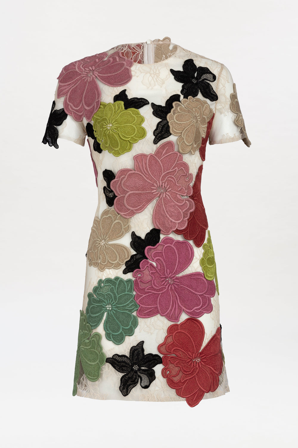Hada Dress: A short-sleeved, knee-length cream dress crafted from lace-like fabric and adorned with large, colorful floral appliqué patterns in pink, green, red, beige, and black, displayed on a white background.