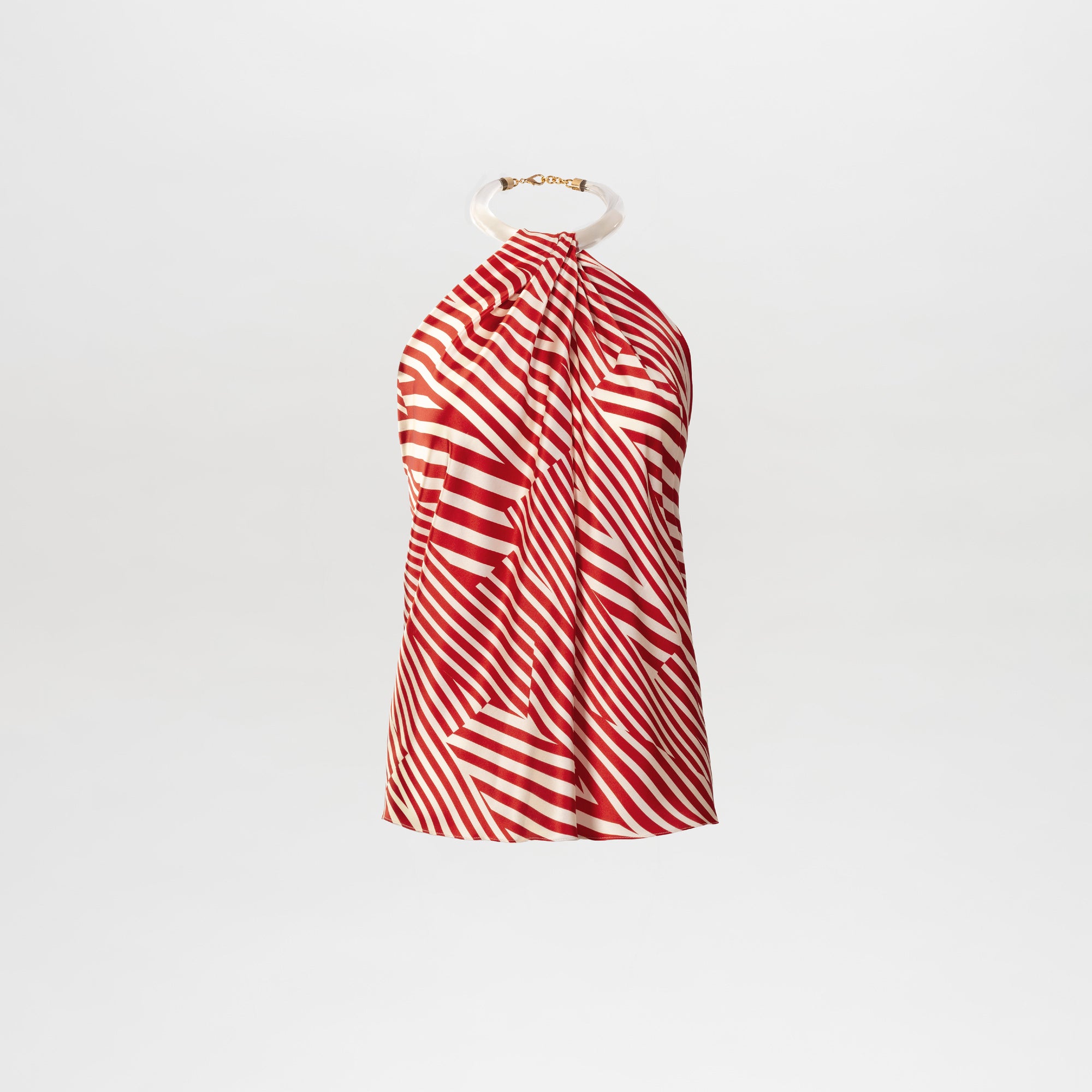 The Dianela Blouse is a sleeveless top made from luxurious Italian fabric with red and white diagonal stripes, featuring a halter neckline accented by a white circular ring and gold chain detail, shown on a plain white background.