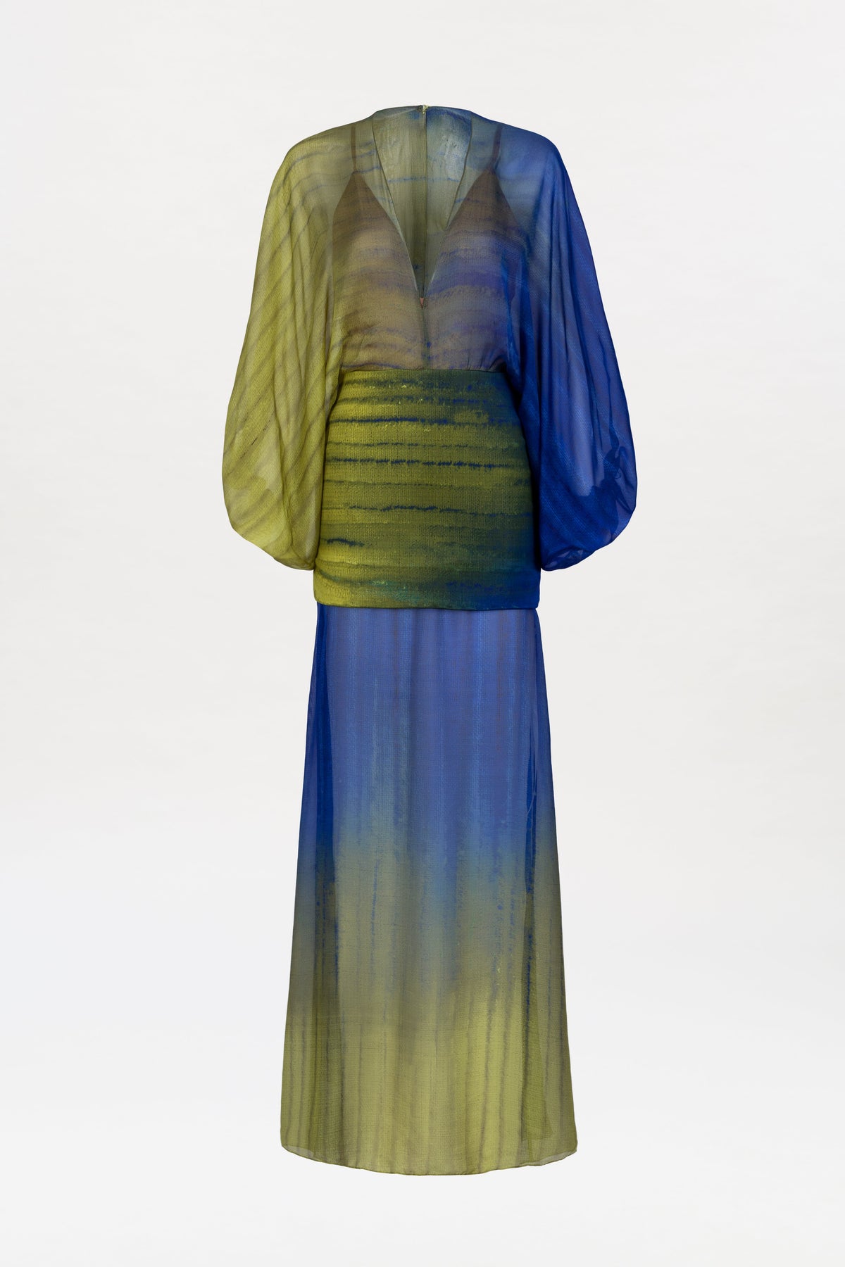 The Lilen Dress is a sheer, long-sleeved design with a deep V-neck and a striking gradient pattern blending blue and yellow-green tones. It features a loose-fitting top and a flowing, ankle-length skirt.