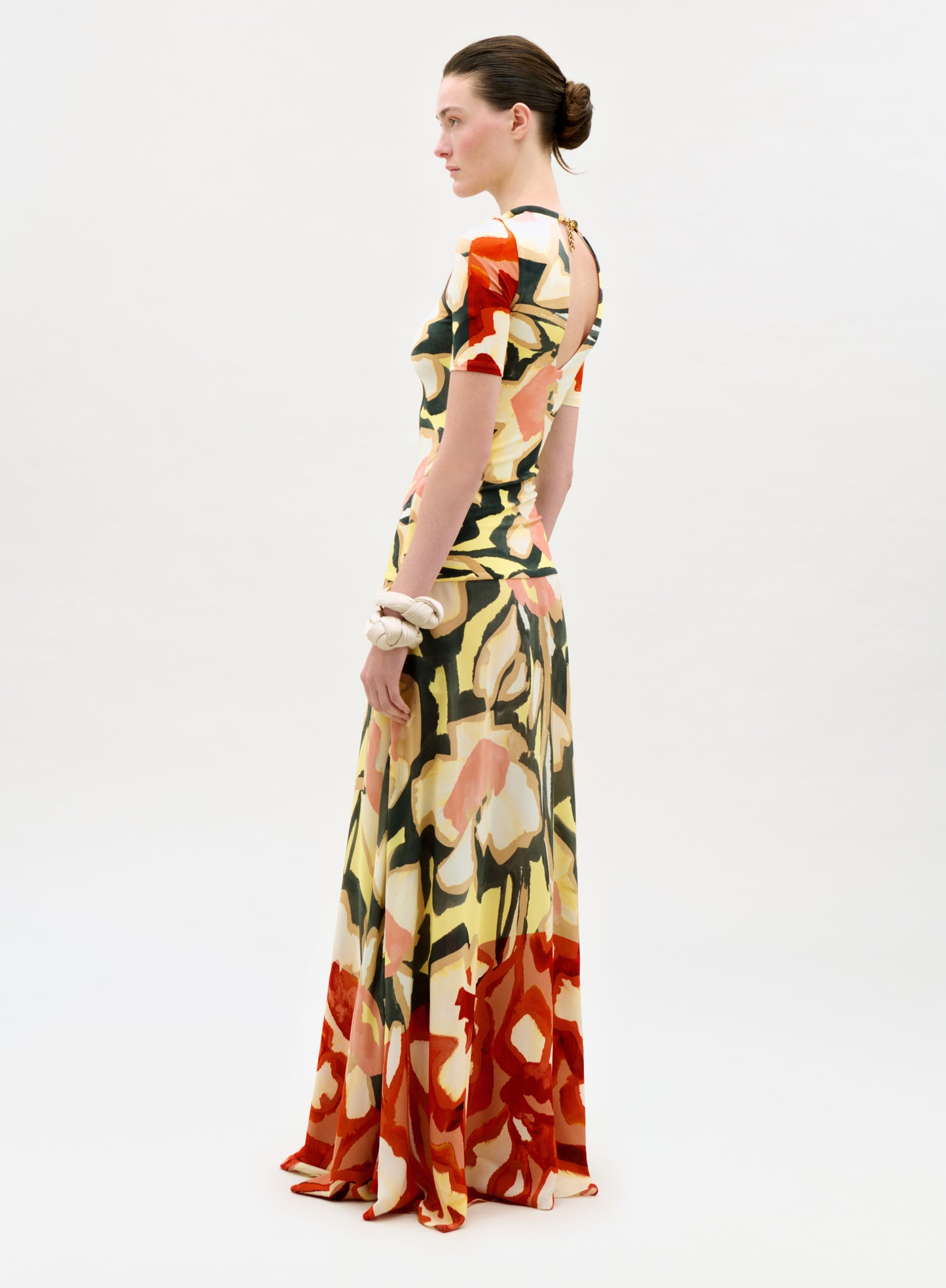 Woman wearing a colorful floral dress on a white background