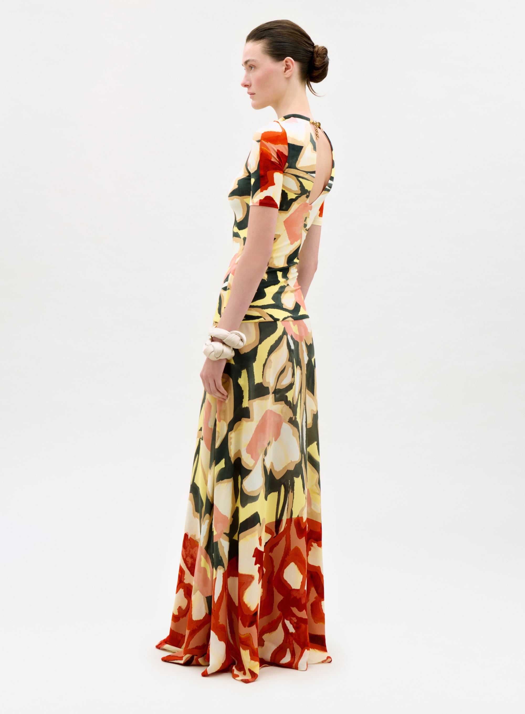 Woman wearing a colorful floral dress on a white background