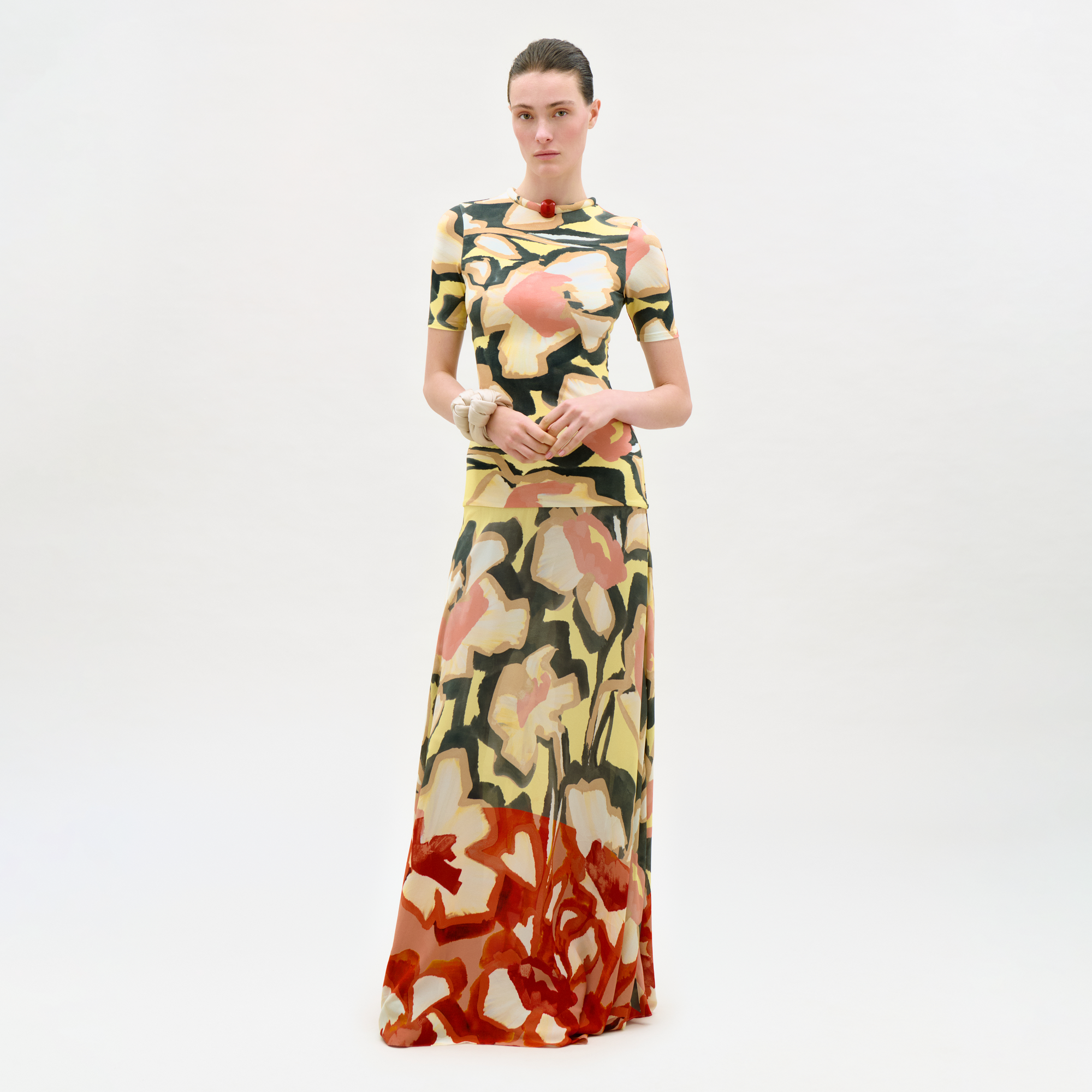 Woman wearing a colorful floral dress on a white background