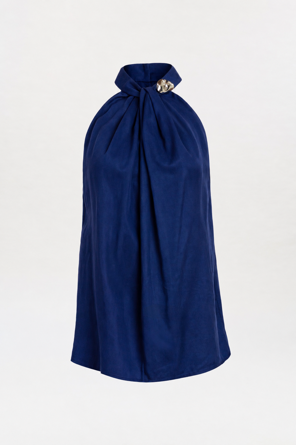 A navy blue, sleeveless halter Shela Blouse featuring a high neckline, gathered fabric at the neck, and a decorative silver brooch detail on the collar, displayed against a plain white background.