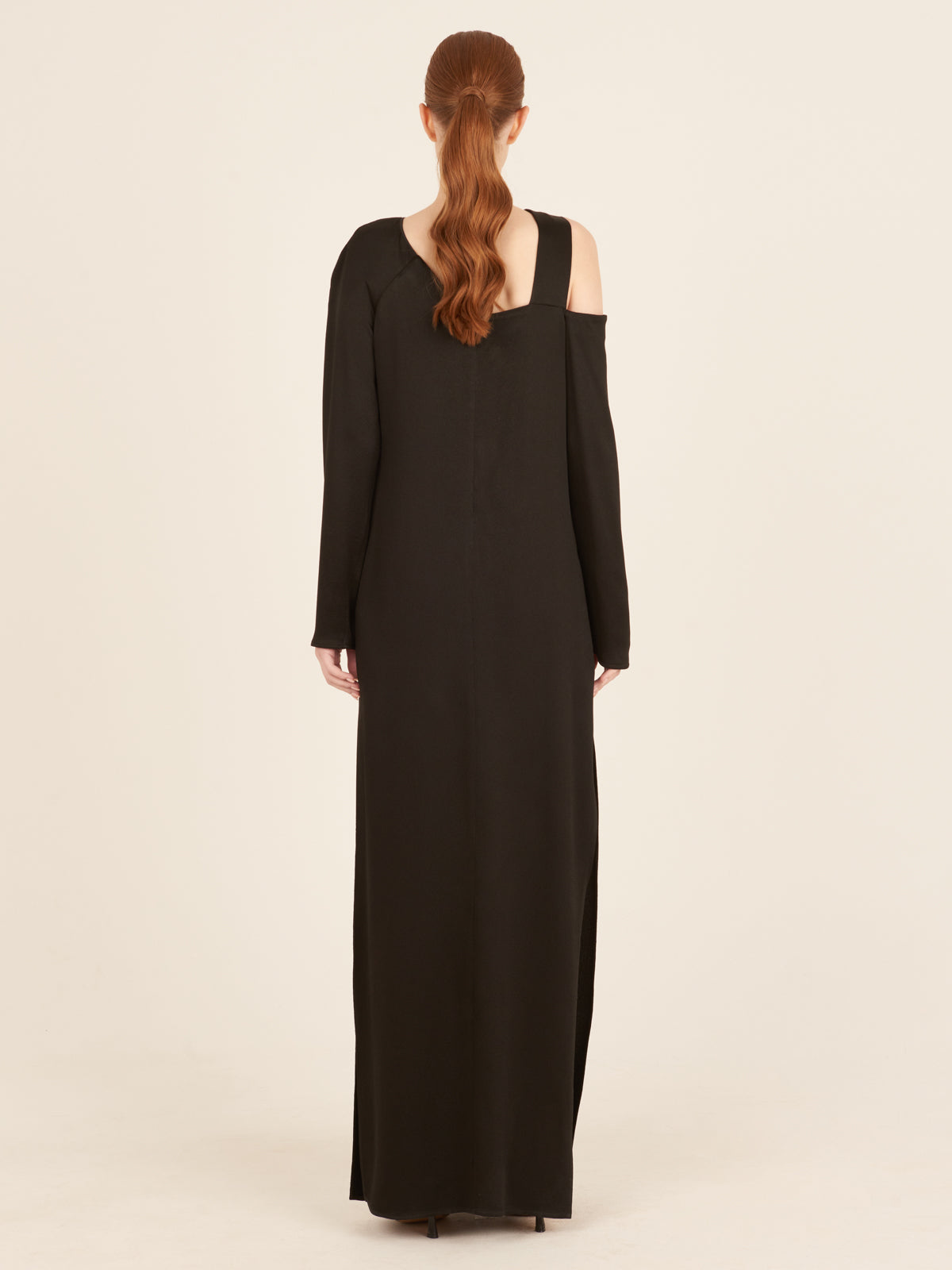 A timeless Turin Dress Black with elegant simplicity, featuring a cut out shoulder.