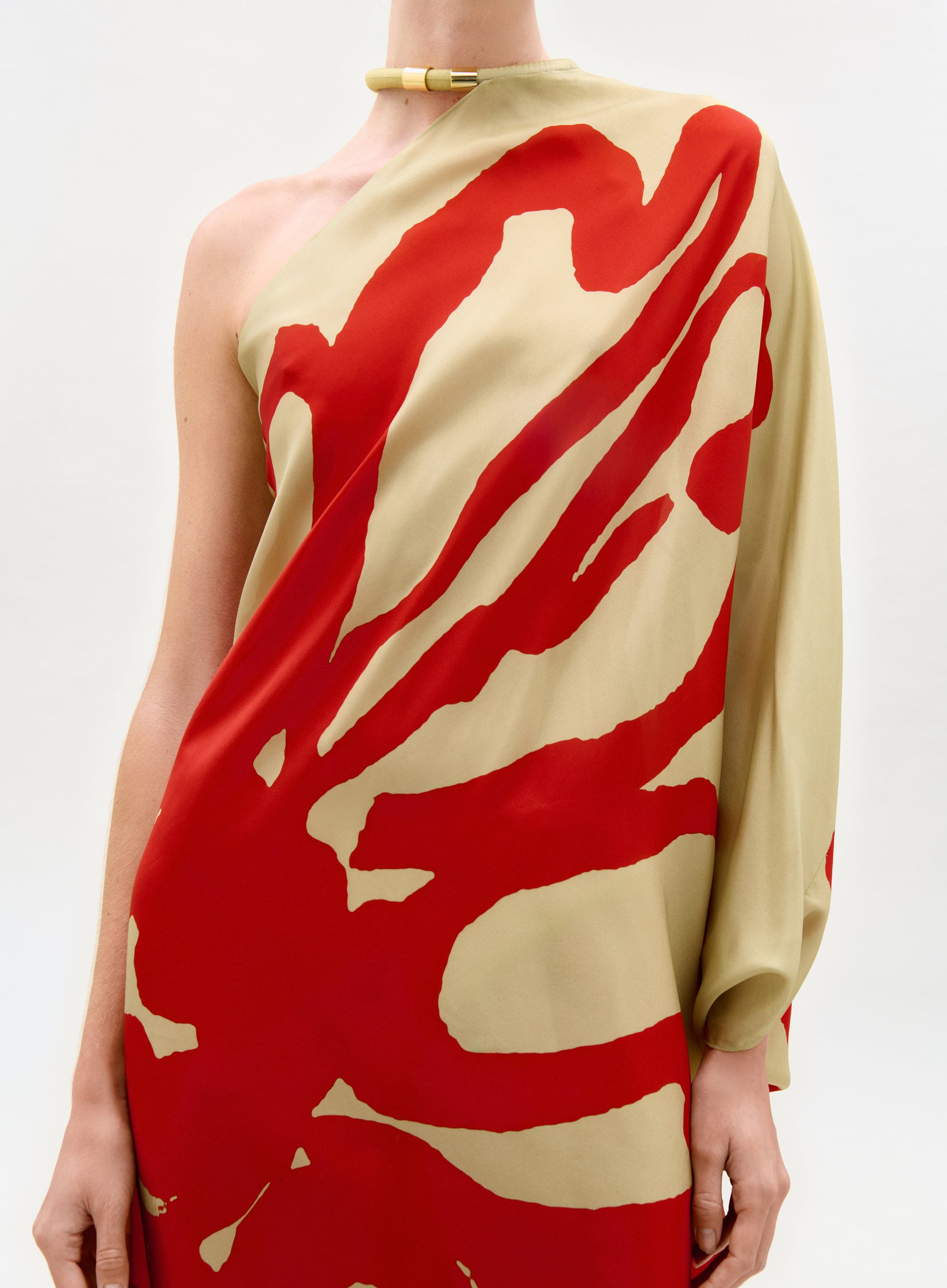 Red and beige abstract patterned dress on a white background