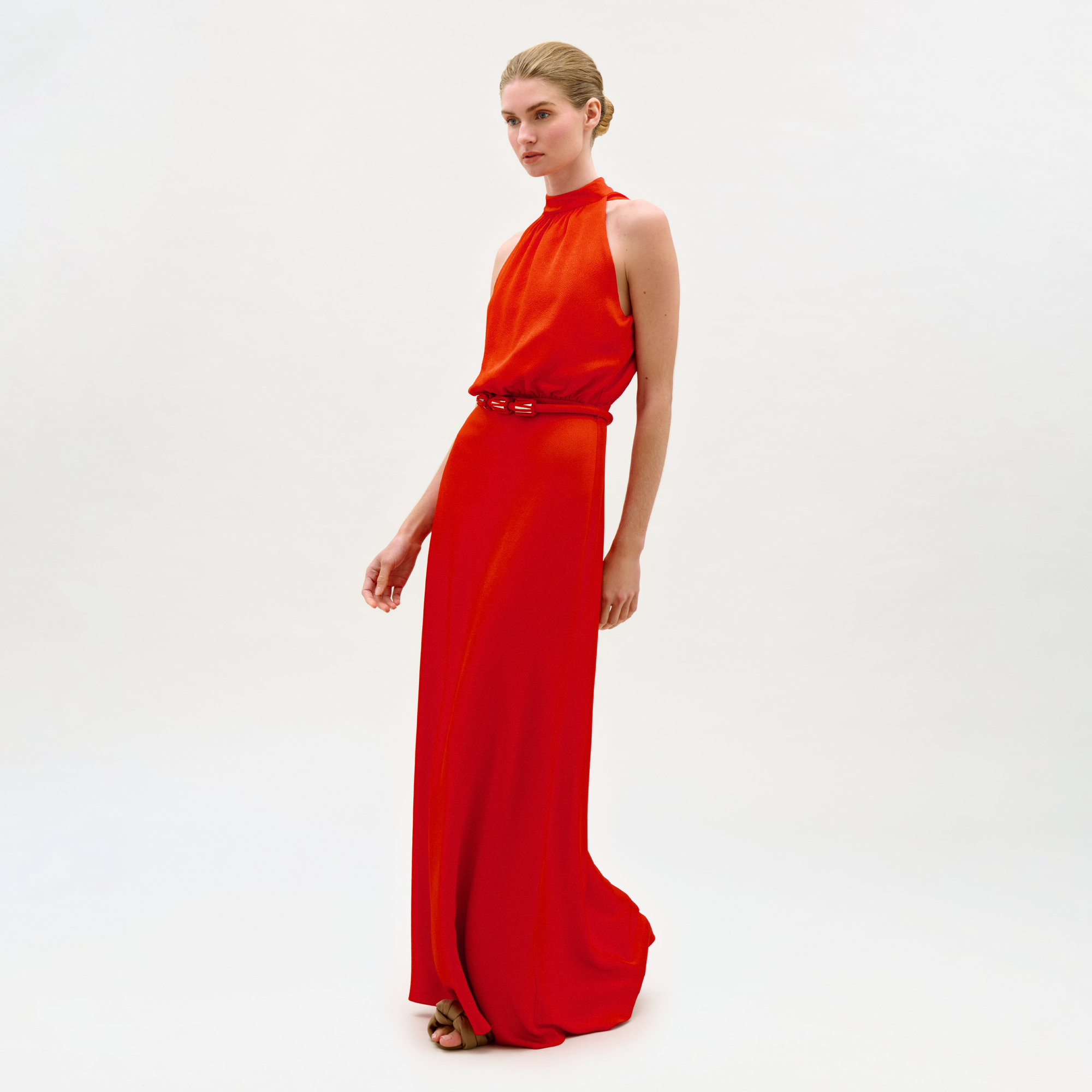 Woman wearing a red evening gown on a white background