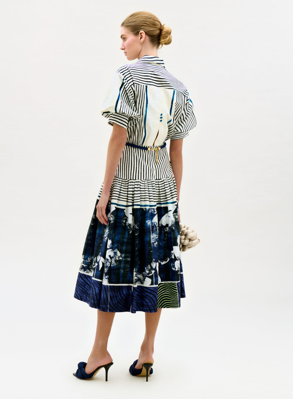 Woman wearing a patterned dress with a white background