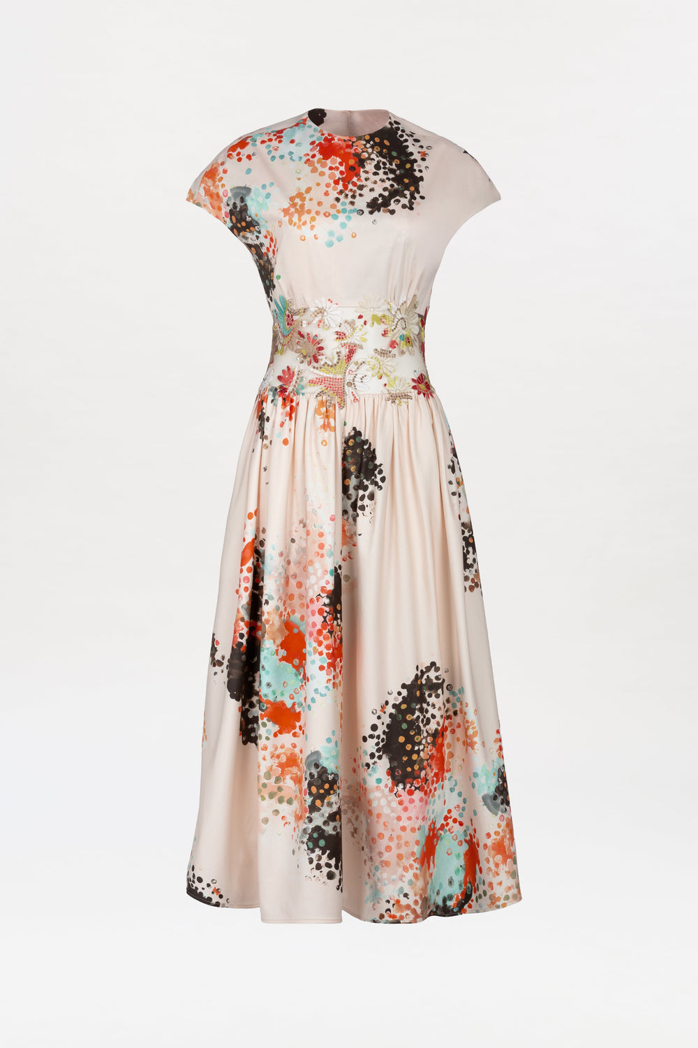 The Macaria Dress is a cream-colored, short-sleeved midi dress with a fitted waist and flared skirt, showcasing a vibrant abstract pattern in orange, blue, black, and teal accents.