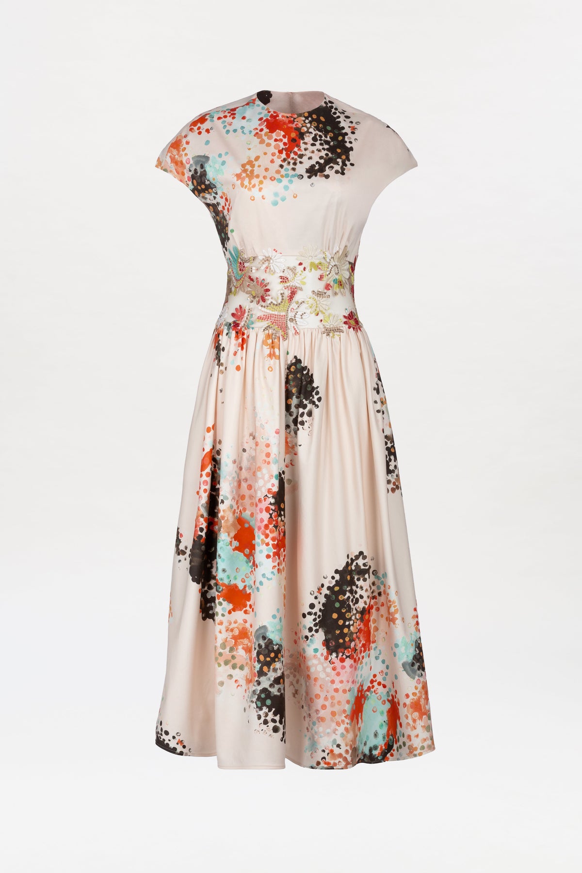 The Macaria Dress is a cream-colored, short-sleeved midi dress with a fitted waist and flared skirt, showcasing a vibrant abstract pattern in orange, blue, black, and teal accents.