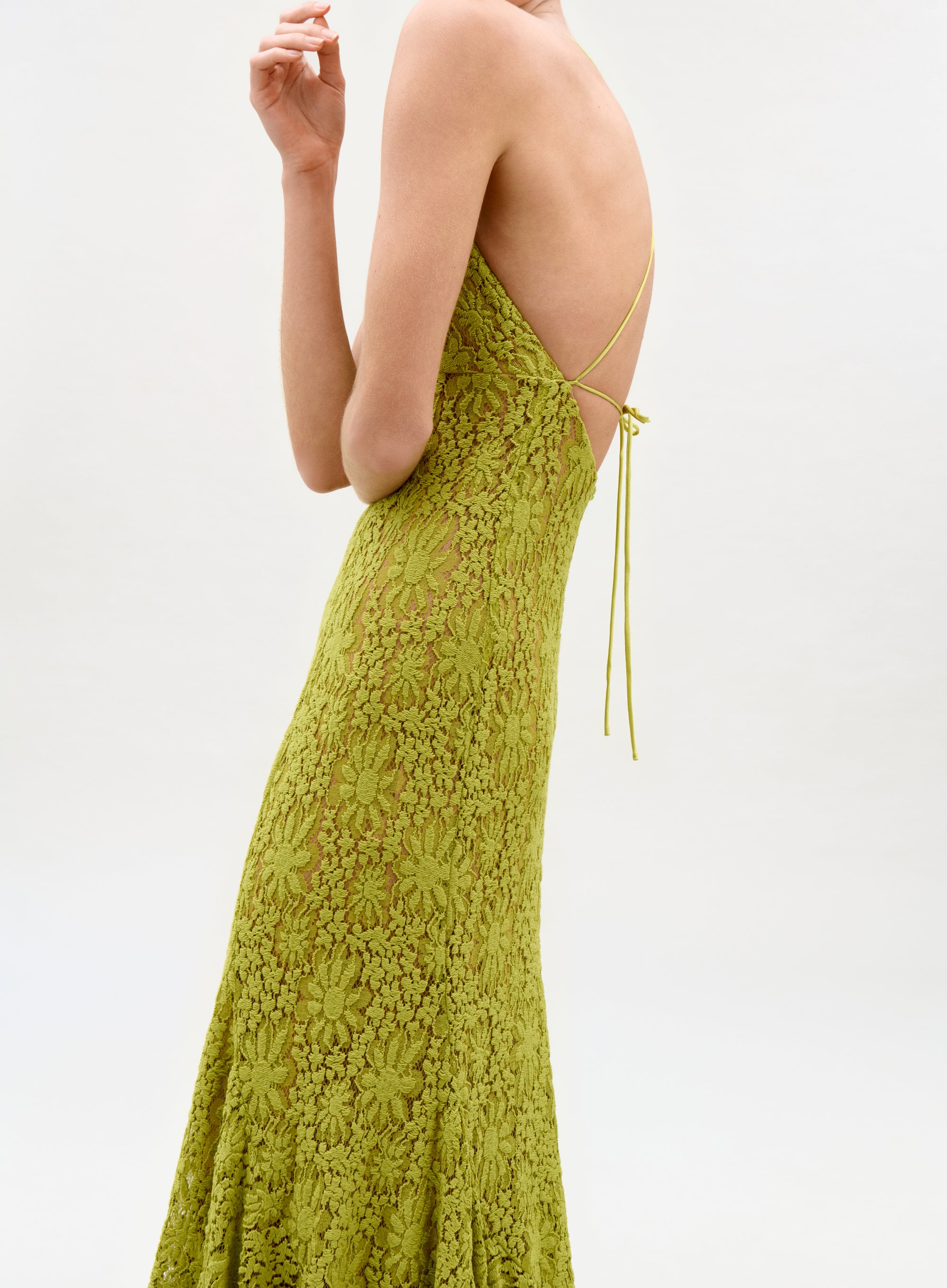 Green lace dress with thin straps on a white background