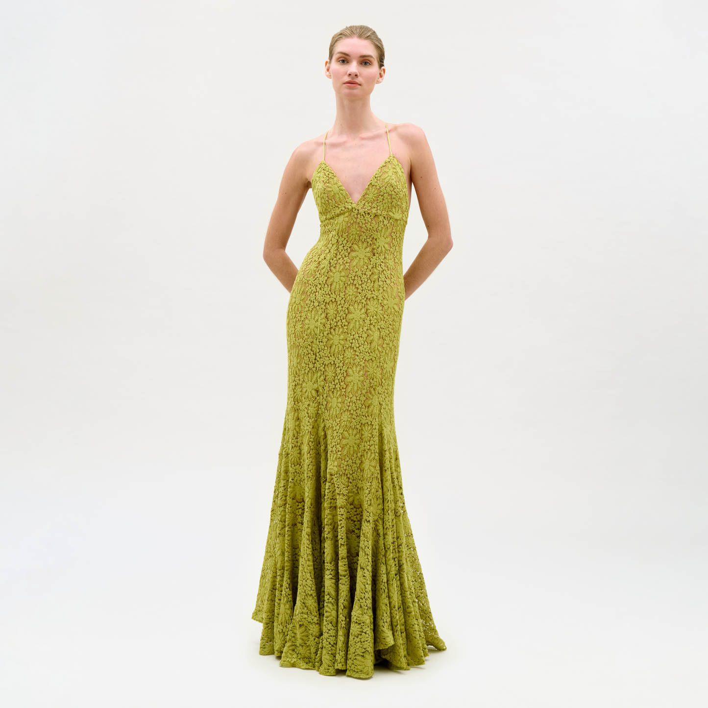 Woman wearing a green evening gown on a white background