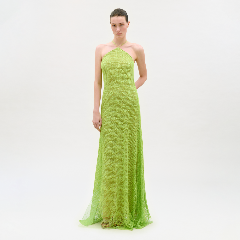 Woman wearing a green strapless gown on a white background