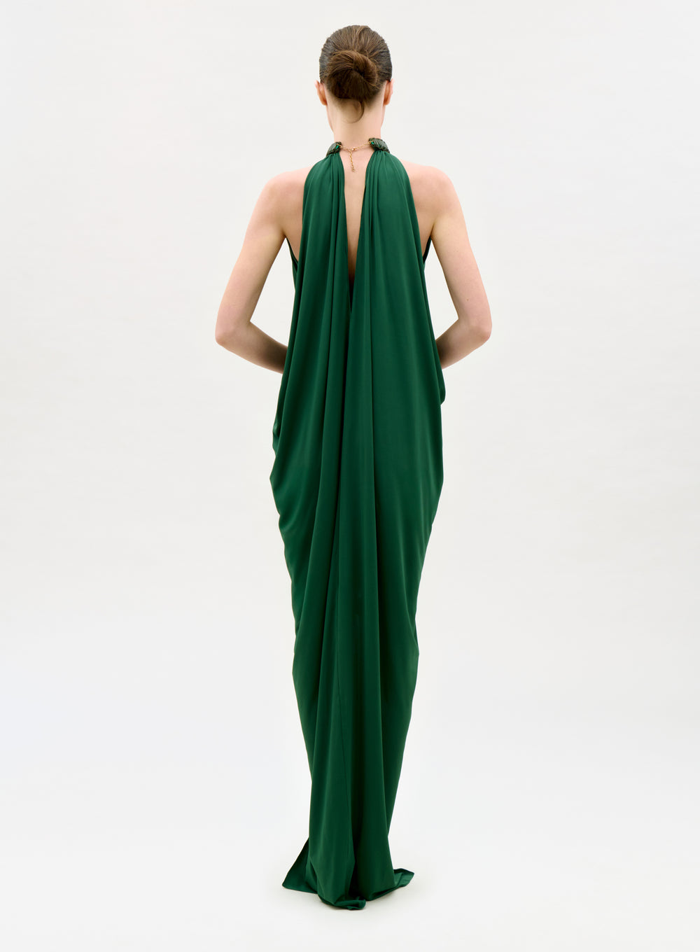 Green evening gown with a deep neckline on a white background