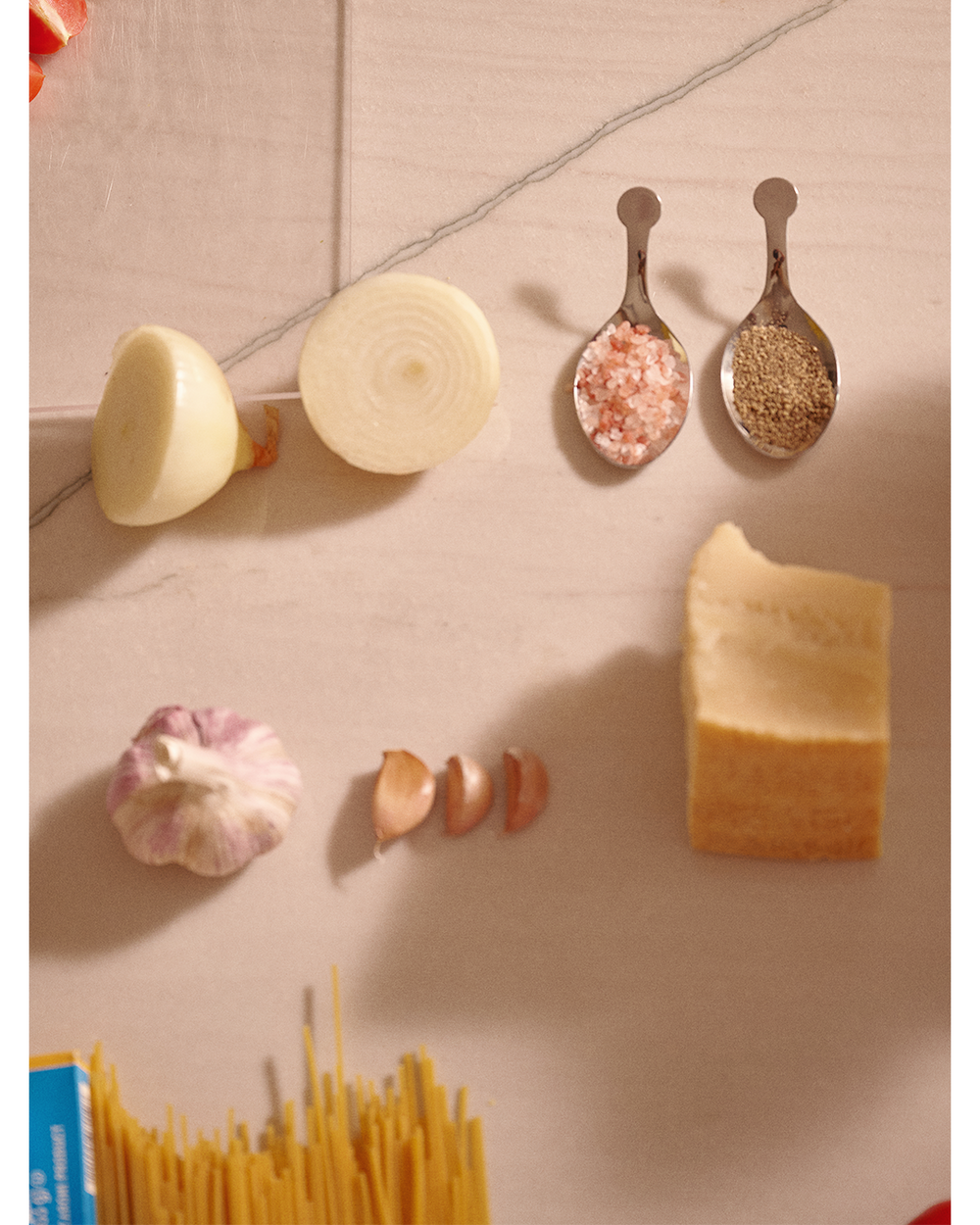 Spices, garlic, and cheese on a textured surface
