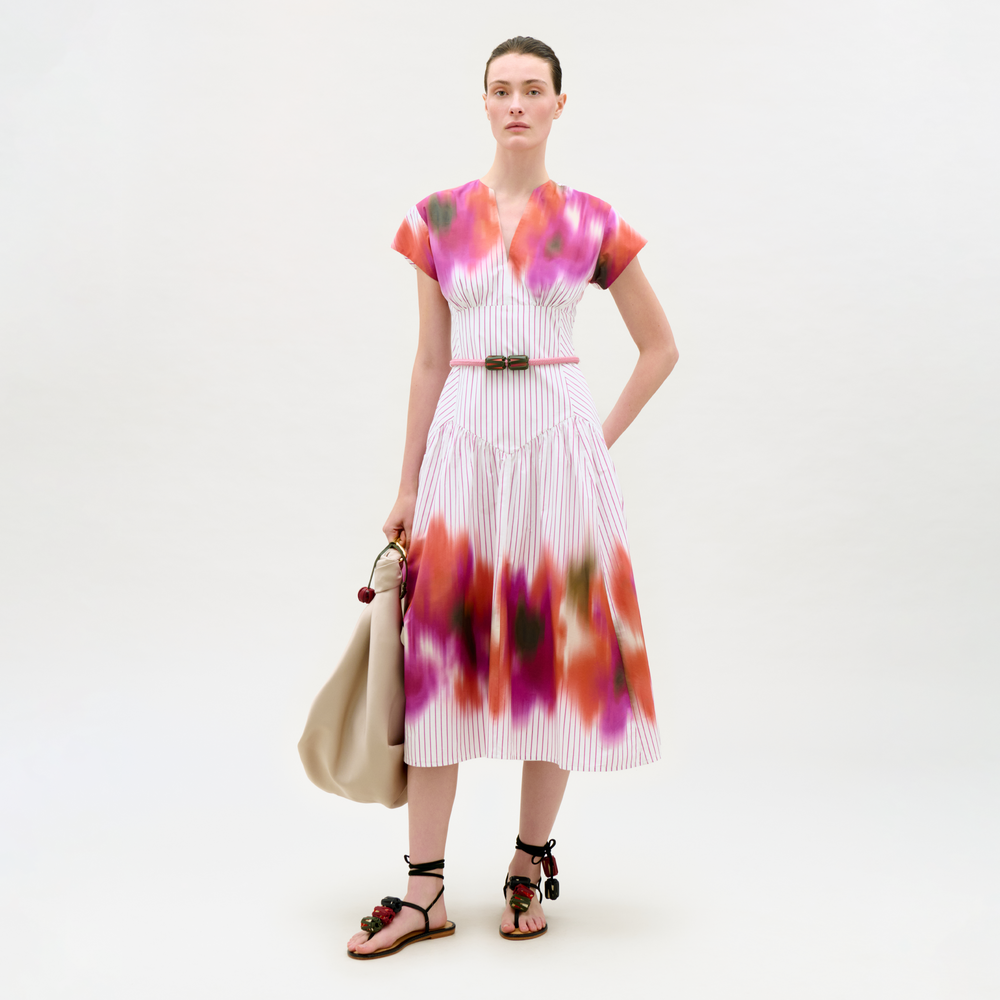 Woman wearing a colorful dress with a white background