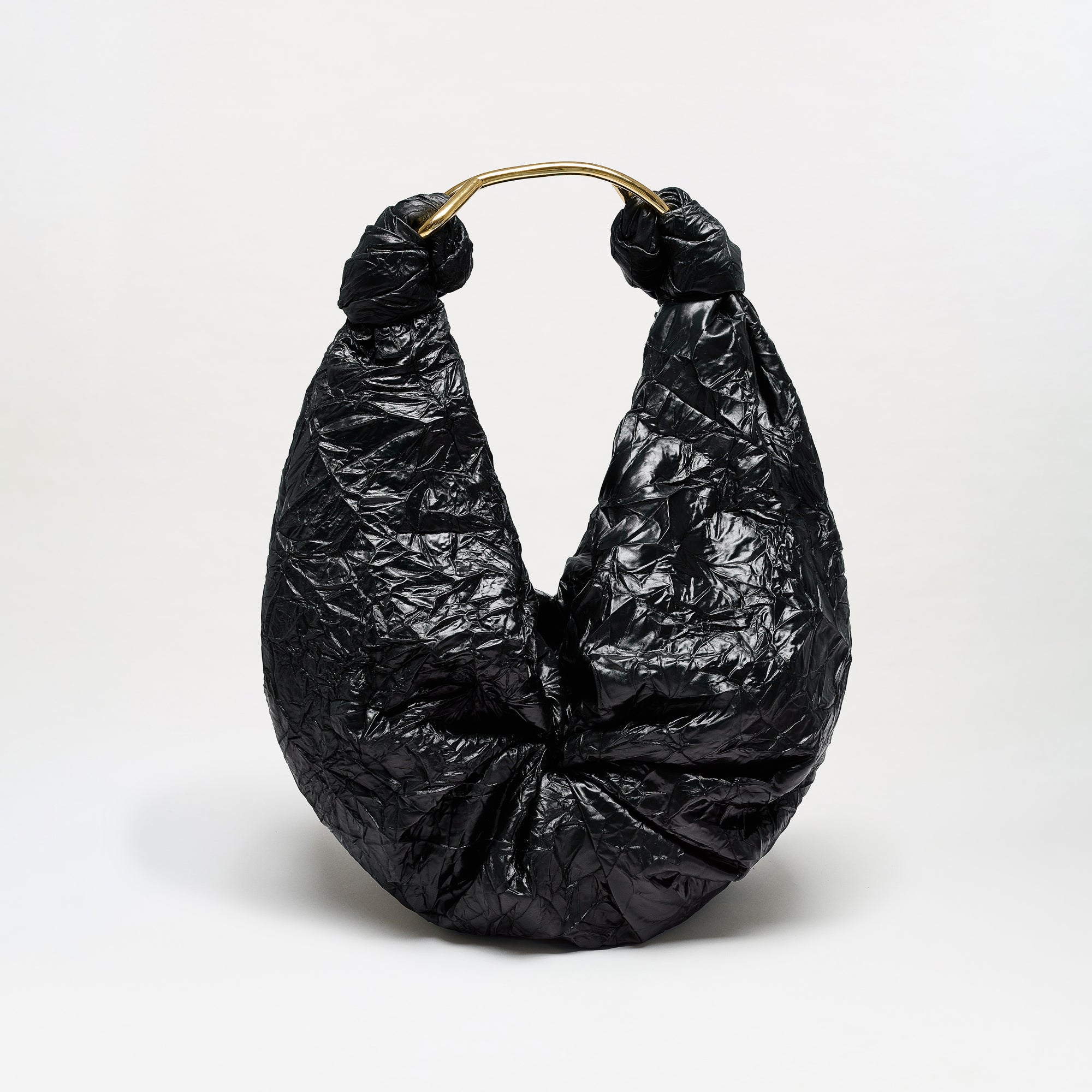 The Sofia Bag (Maxi) is a black, crinkled hobo-style maxi bag featuring a gold-toned handle and crafted from luxurious Italian fabric, displayed against a plain white background.