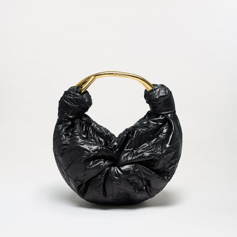 The Sofia Bag (Small) is a black, crescent-shaped bag crafted from luxurious Italian fabric, featuring a crinkled texture and finished with a shiny gold-toned curved handle. It is presented against a plain light background.