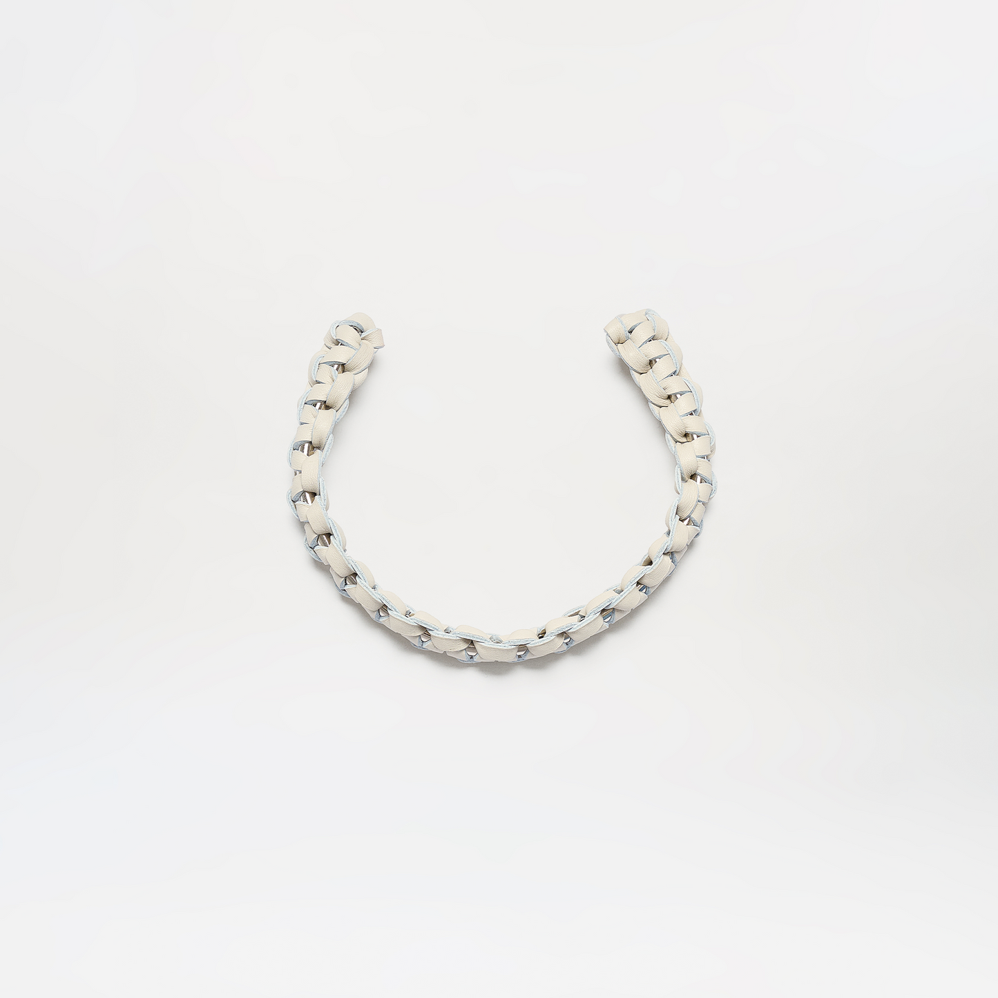 The Talal Chocker is a short, thick, white braided rope displayed in a loose U-shape against a plain white background.