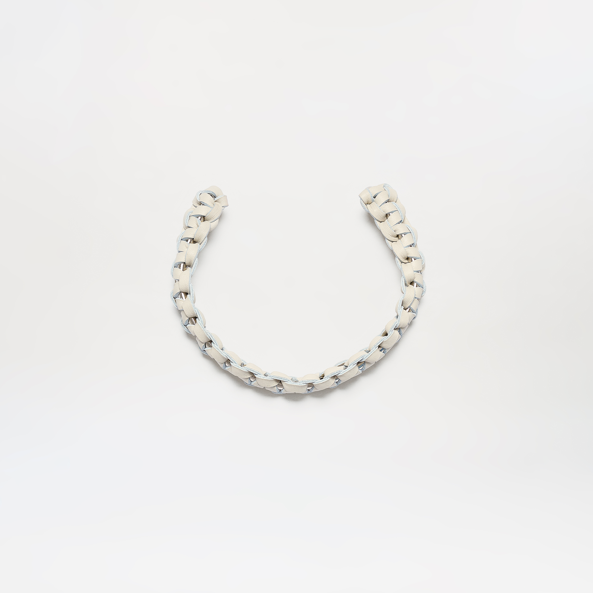 The Talal Chocker is a short, thick, white braided rope displayed in a loose U-shape against a plain white background.