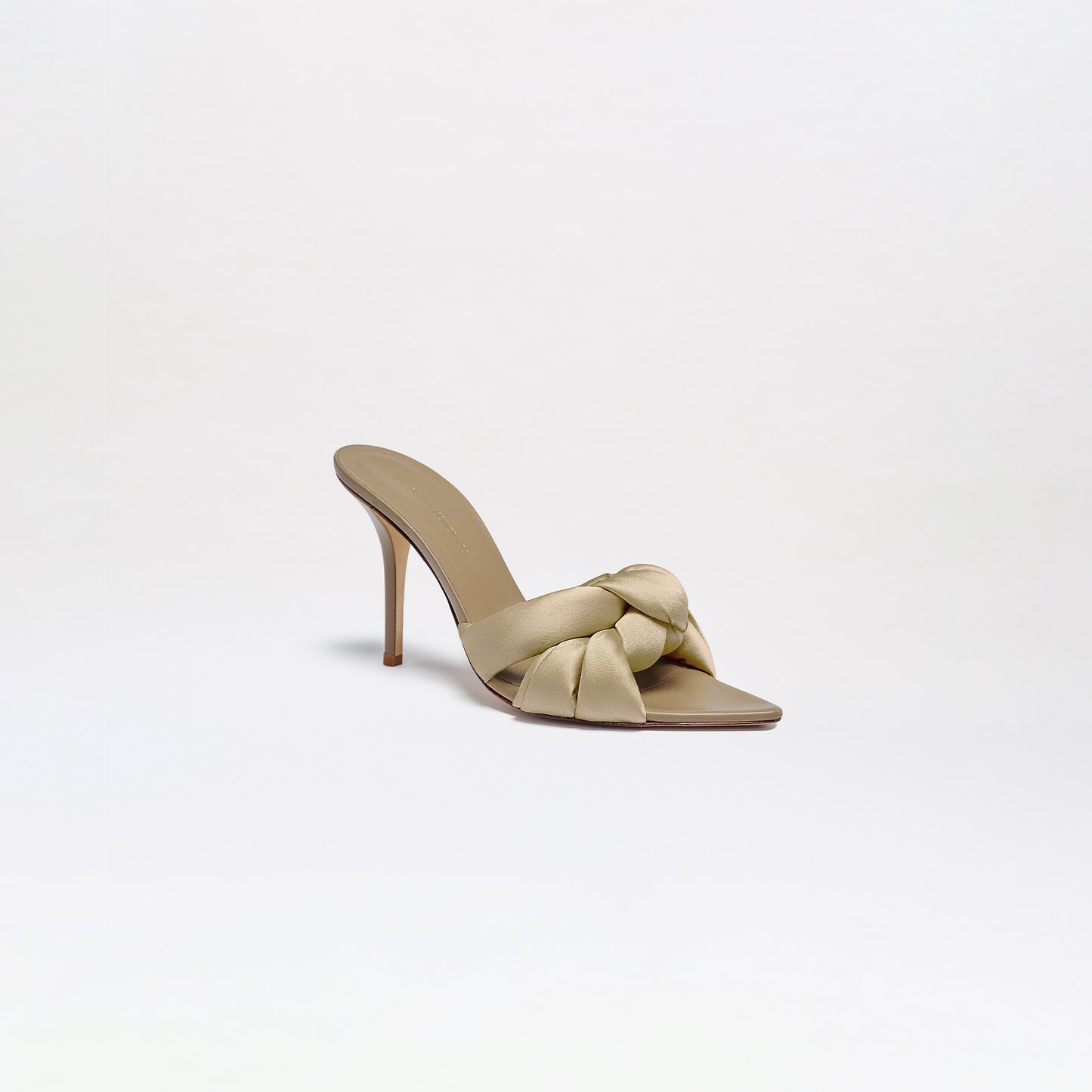 Ana Heels: Sleek beige high-heel sandals made from Italian leather, featuring an open toe, wide knotted strap, and thin stiletto heel. This minimalist mule is shown on a plain white background.