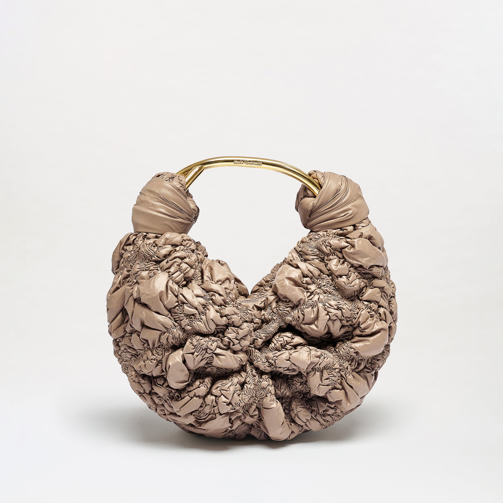 The Sofia Bag (Small) is a beige, textured handbag with a puffy ruched design and a rounded gold handle, shown against a plain white background.