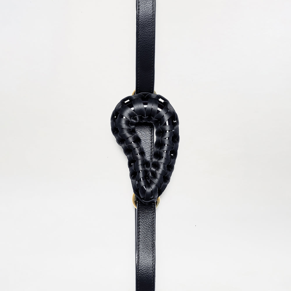 The Renata Belt features a black woven leather loop in a teardrop shape, centered on a vertical black leather strap, shown against a plain white background.