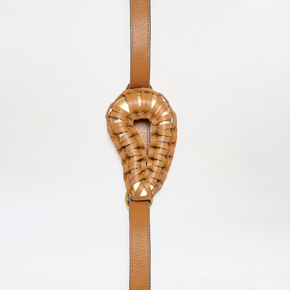 The Renata Belt features a brown leather strap with an intricately woven, oval-shaped padded center, displayed against a plain white background.