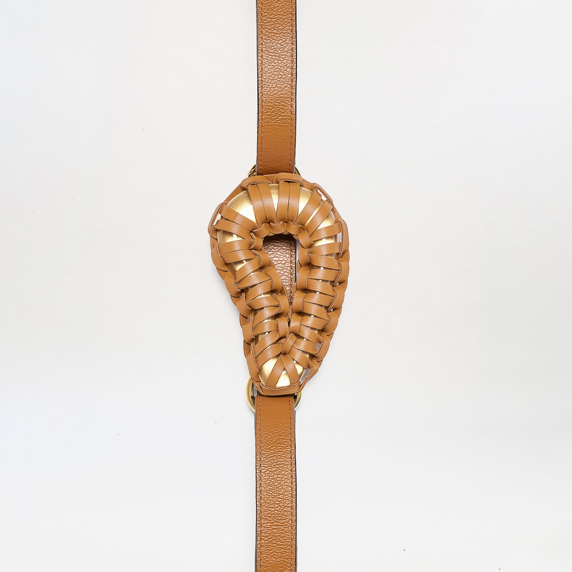 The Renata Belt features a brown leather strap with an intricately woven, oval-shaped padded center, displayed against a plain white background.