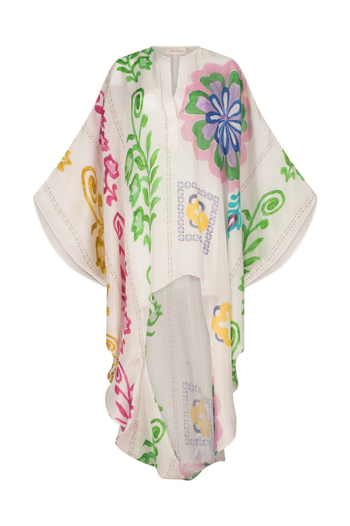 A white poncho with Adaya Tunic Multicolor Floral Print designs.