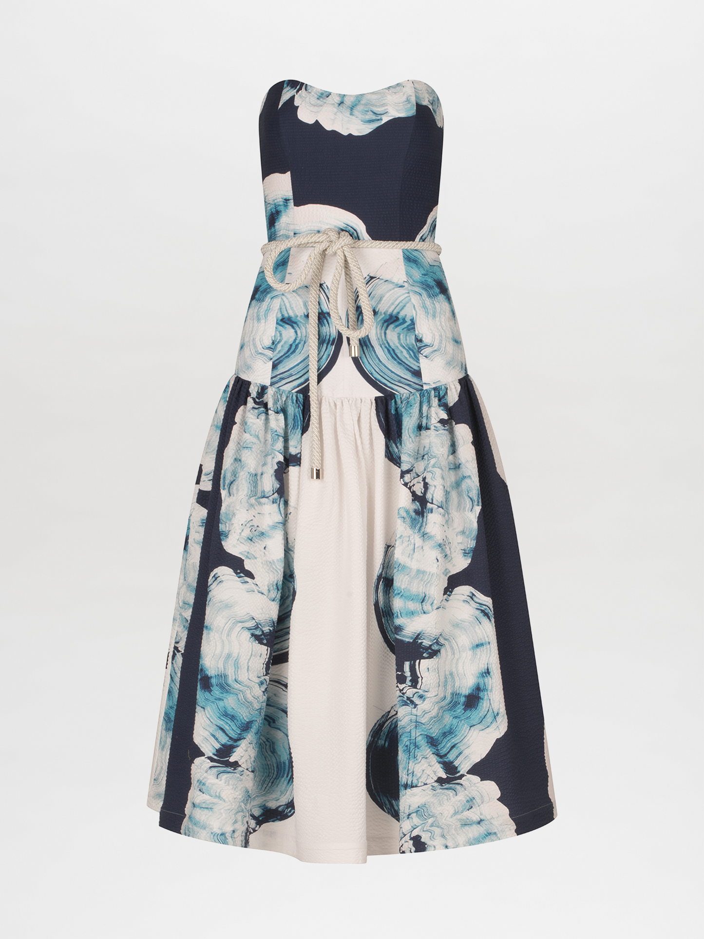 A Adelaida Dress Navy Abstract Wave with a belt.