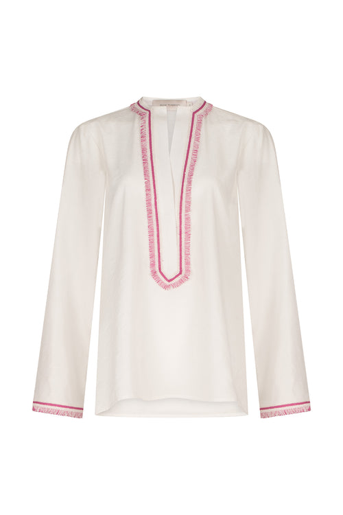 An Anisa Blouse White with pink trim and V neckline.