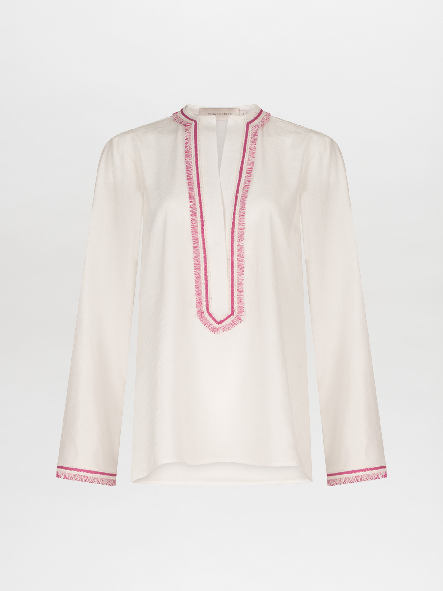 An Anisa Blouse White with pink trim and V neckline.