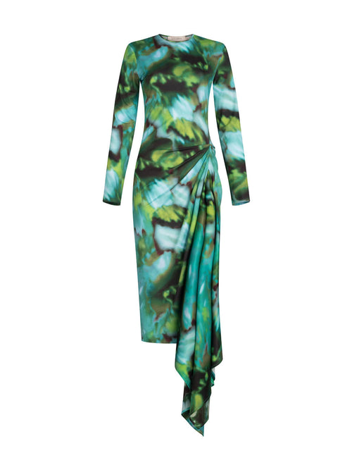 Ananya Dress Juniper Green with a green and blue abstract leaf pattern and asymmetrically draped skirt, isolated on a white background.