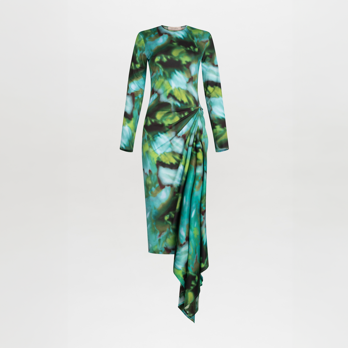 Ananya Dress Juniper Green with a green and blue abstract leaf pattern and asymmetrically draped skirt, isolated on a white background.