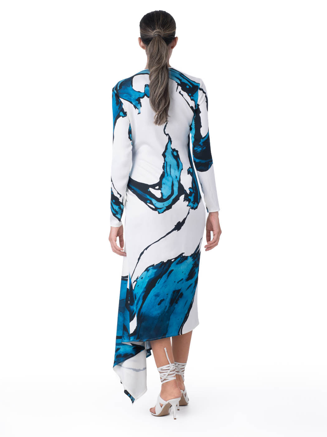 Ananya Dress Multi Abstract Waves with bold blue abstract print design, featuring an asymmetrically draped skirt, displayed on a white background.