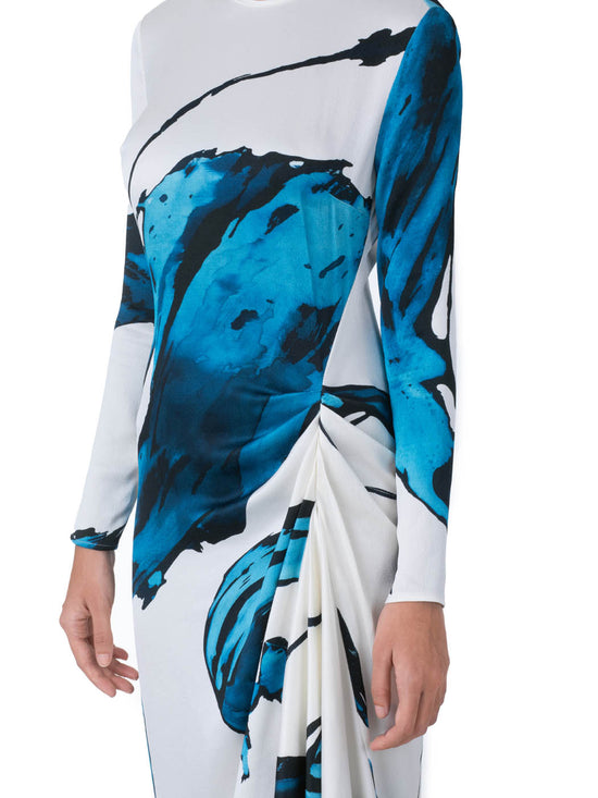 Ananya Dress Multi Abstract Waves with bold blue abstract print design, featuring an asymmetrically draped skirt, displayed on a white background.