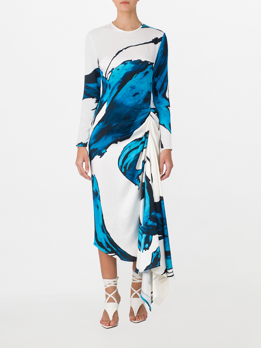 Ananya Dress Multi Abstract Waves with bold blue abstract print design, featuring an asymmetrically draped skirt, displayed on a white background.