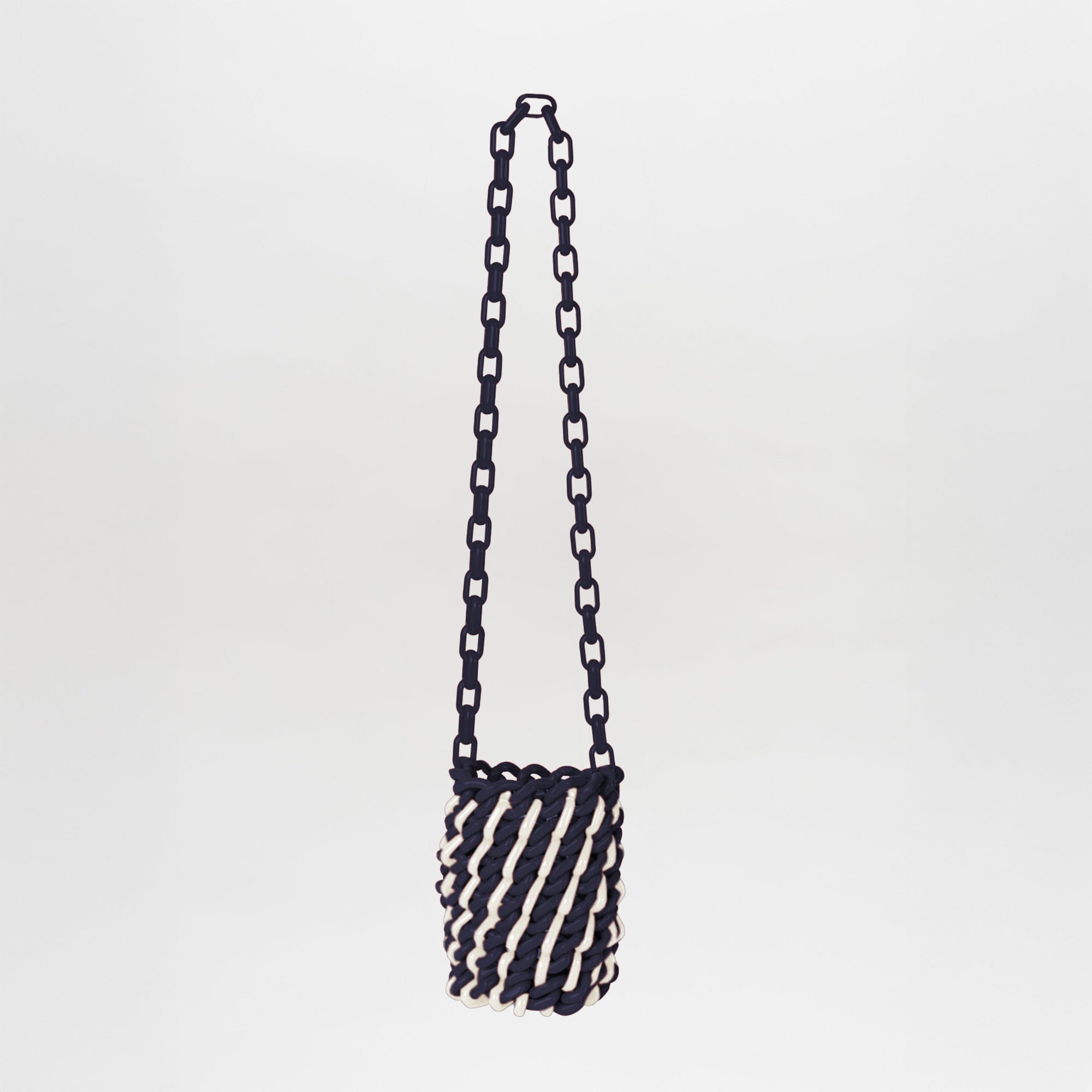 The Anise Bag Navy White is a small cylindrical bag with a chunky chain strap, twisted navy-and-white rope design, and unique resin rings, set against a plain background.