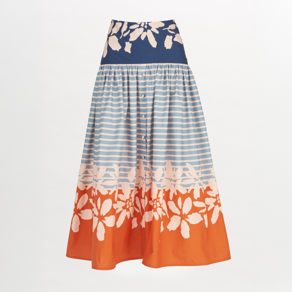 The Apia Skirt Celeste Orange is a flared midi design that features horizontal blue stripes and a wide blue and white floral band at the top. The hem is embellished with an eye-catching celeste orange floral border.