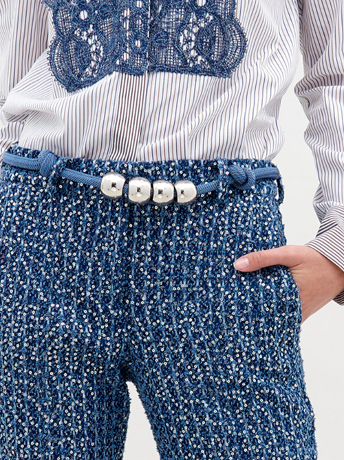 A Sam Belt Indigo with three silver metallic beads in the center, set against a white background. Pre-order now for shipping starting November 15, 2024.