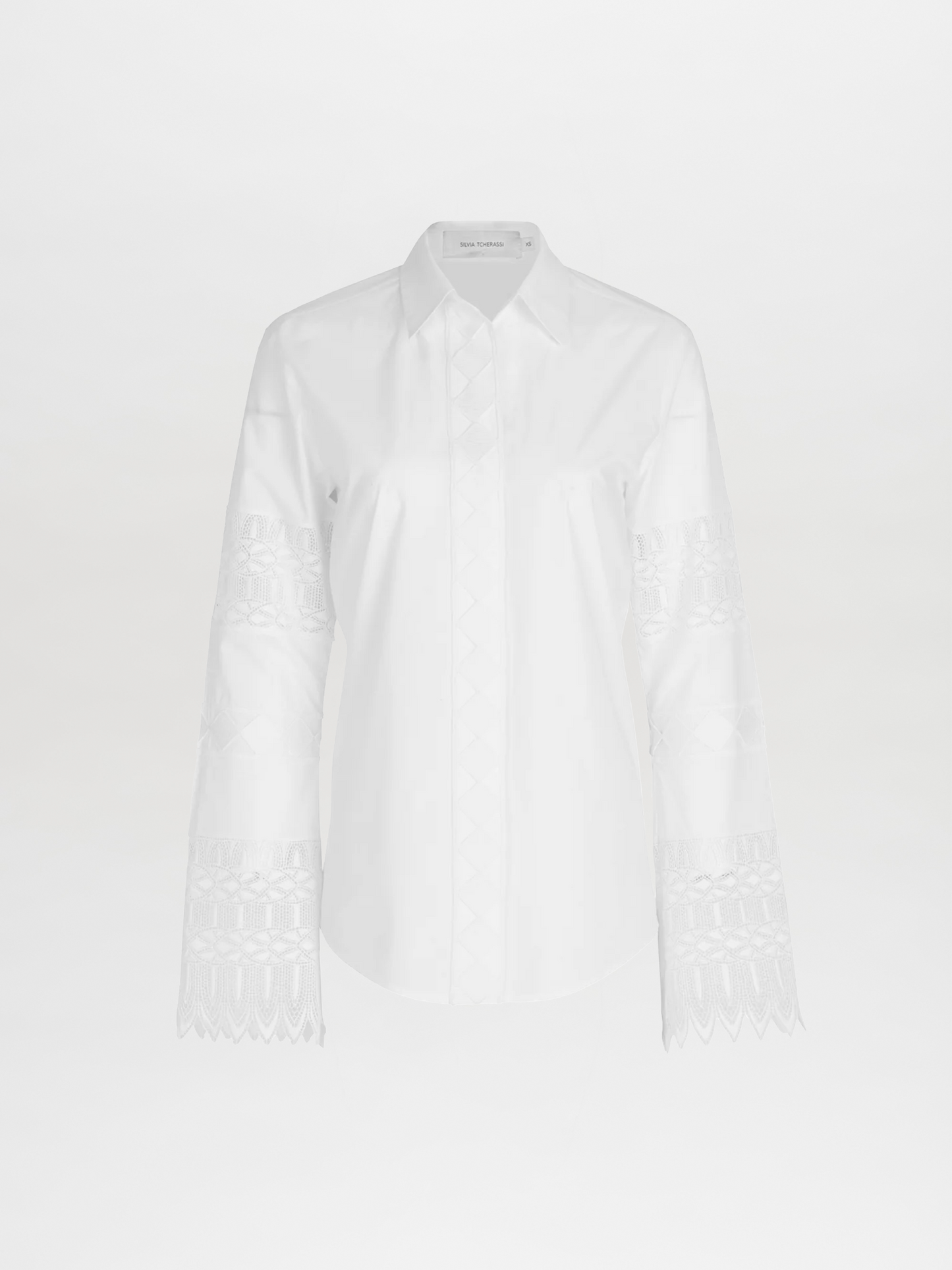 A Aspasia Blouse White with guipure lace detailing on the sleeves.