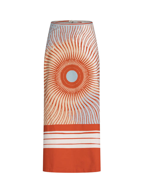 Long high-waisted Atira Skirt Sausalito Sunset with an orange and white sunburst pattern and horizontal stripes at the hem.