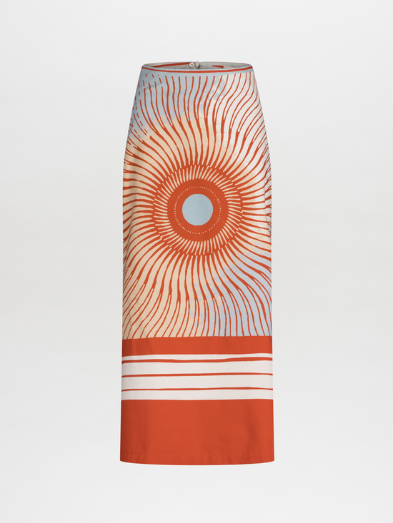 Long high-waisted Atira Skirt Sausalito Sunset with an orange and white sunburst pattern and horizontal stripes at the hem.