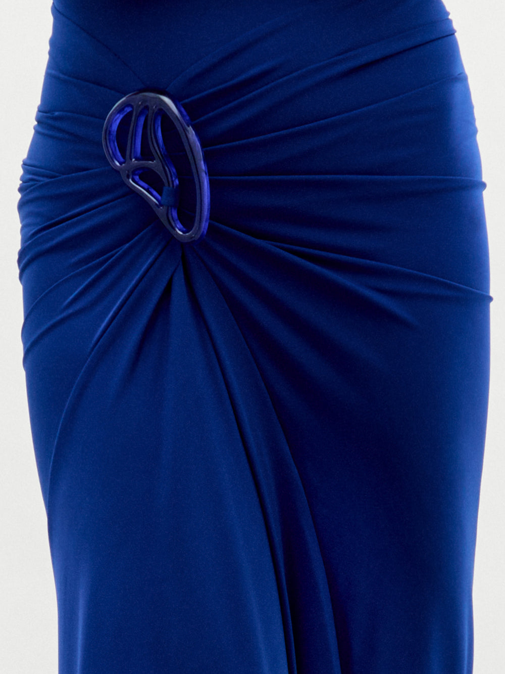 A woman poses against a plain white background, wearing the Bogna Dress—a sleeveless, high-neck maxi crafted from luxurious Italian fabric with elegant waist draping.