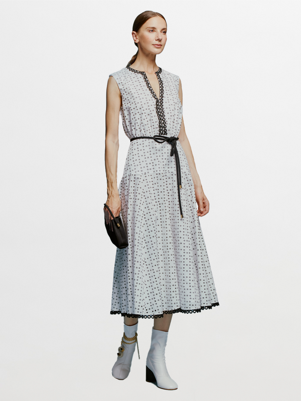 The model is wearing a Bora Dress White Black Dots.