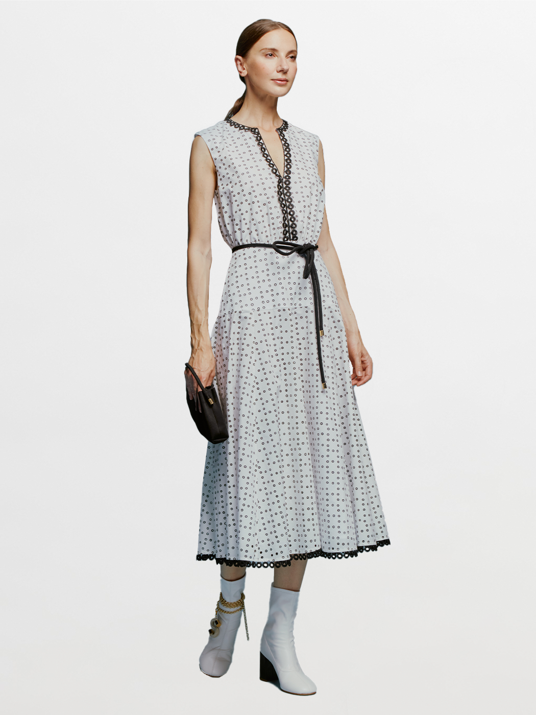 The model is wearing a Bora Dress White Black Dots.