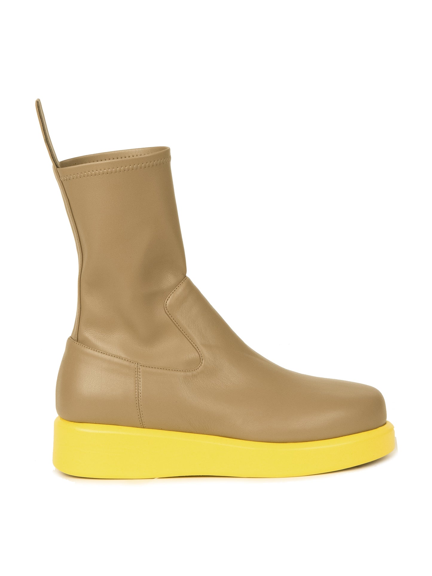 The Baia Boots Taupe Lemon features a single taupe boot with a tall shaft crafted from supple stretch calf leather and a thick lemon-colored sole, showcased from the side against a white background, offering a chic and trendsetting look.