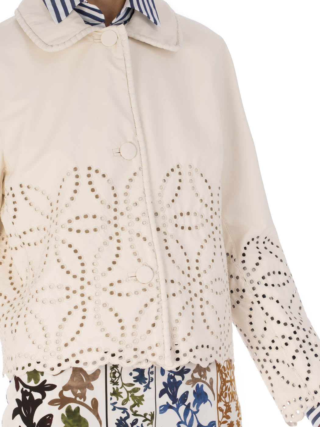 A white Belen Jacket Pearl with a high collar and decorative eyelet perforations on a plain background.