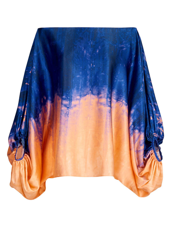 Sentence with product name: Bellagio Blouse Mediterranean Coral Blue draped over an invisible object, primarily in shades of blue and orange, isolated on a white background.
