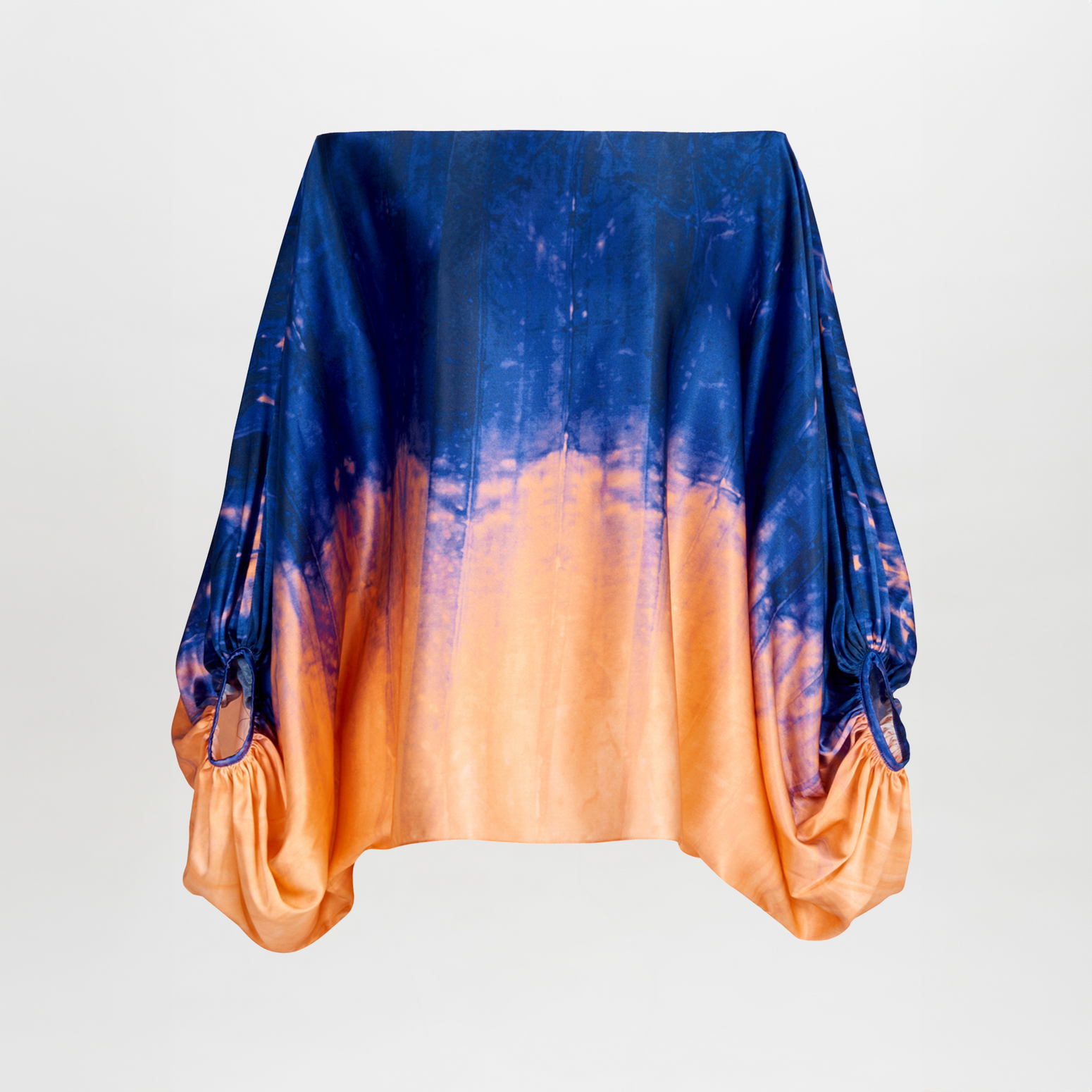 Sentence with product name: Bellagio Blouse Mediterranean Coral Blue draped over an invisible object, primarily in shades of blue and orange, isolated on a white background.